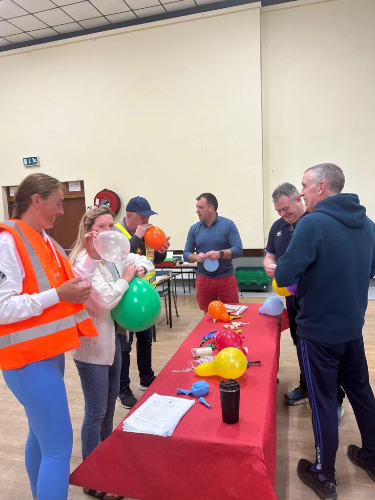 People from the community blowing up balloons in Labasheeda hall for St. Kieran’s Community Centre